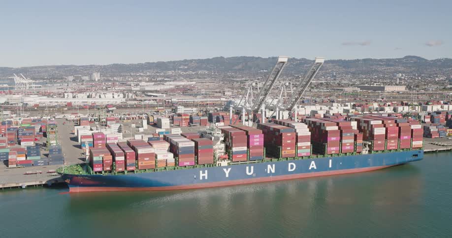 Loaded container ship sits at waterfront dock on a misty day