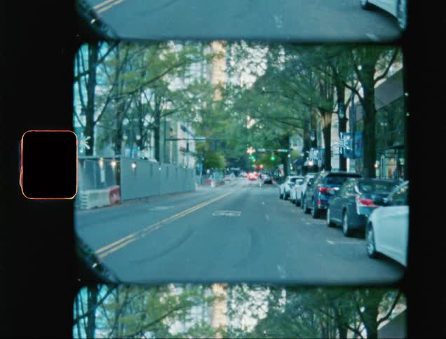 A view from inside a car driving on an asphalt street within the city