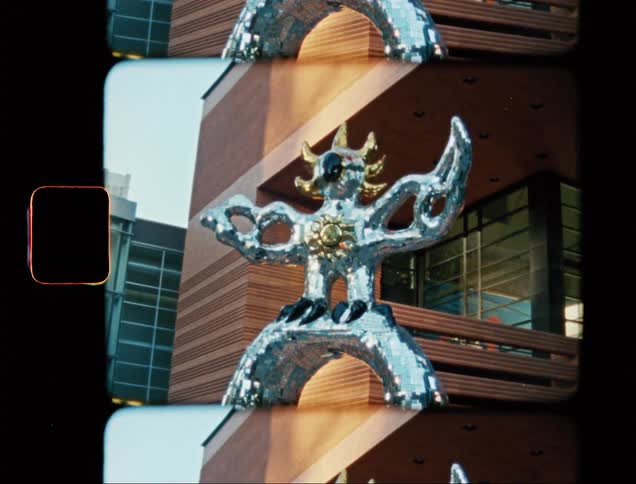 A metal statue is in front of the building