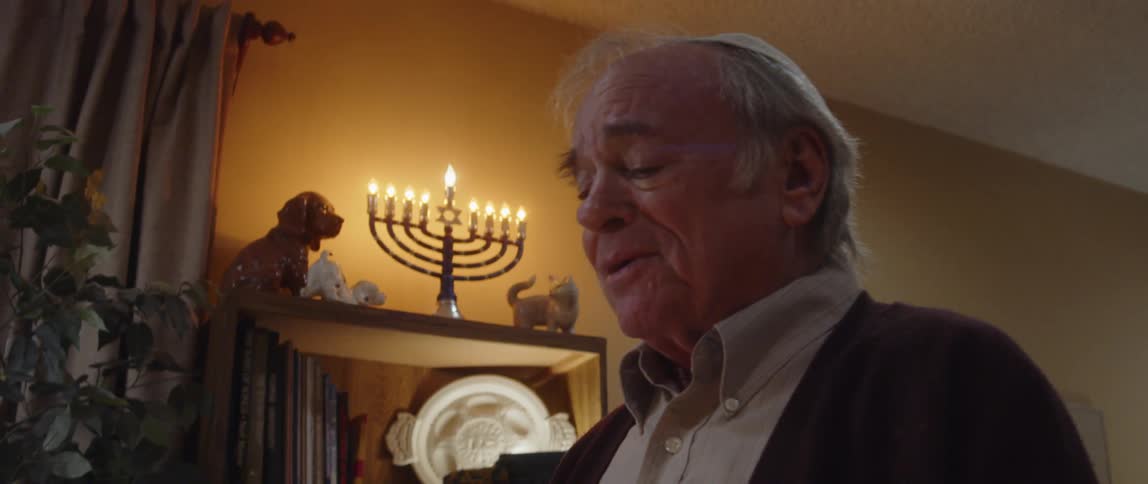 A sad elderly jewish man speaking during a religious ceremony