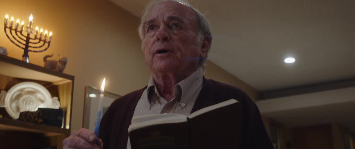 A man singing a bible song holding a candle