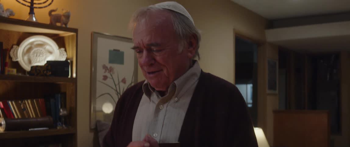 A man singing and holding a bible in the room