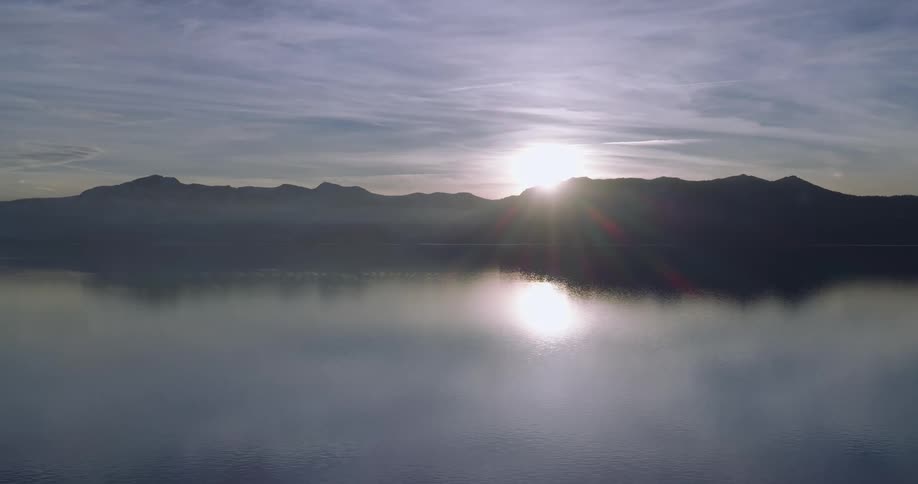 The sun is rising behind the mountains