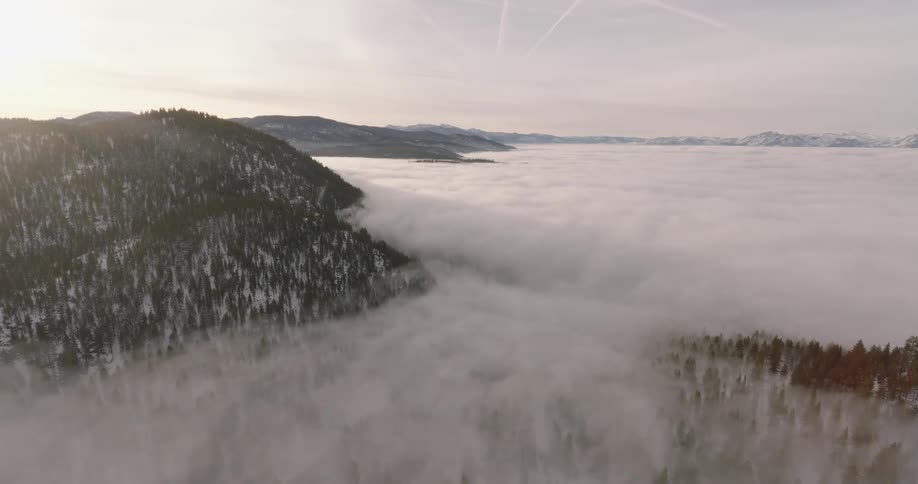 Some hills with mountains and the lower part is full of dense fog