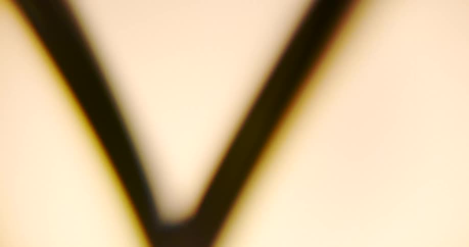 A piece of metal rotates amidst alternating darkness and light