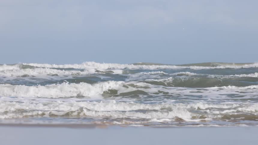 Waves crash against the shore