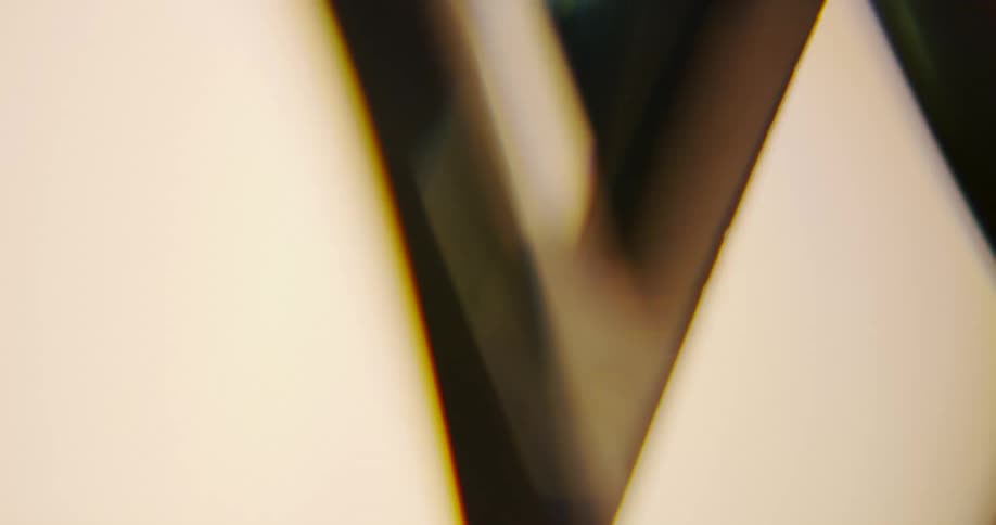 Close up of geometrical shapes swinging and reflecting light