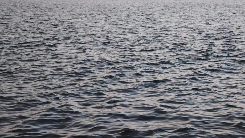 Light reflects on the water as it ripples and waves