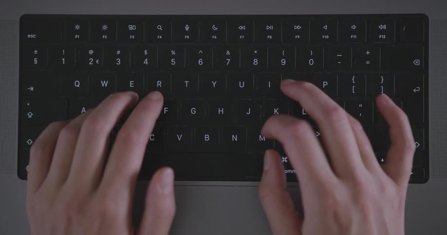 Human fingers pressing some buttons on a black computer keyboard