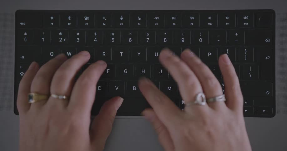 Close up of hands typing on laptop keyboard