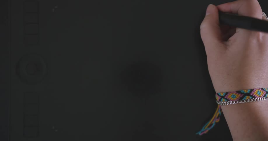 Person draws on surface creating a drawing slightly darker than the background