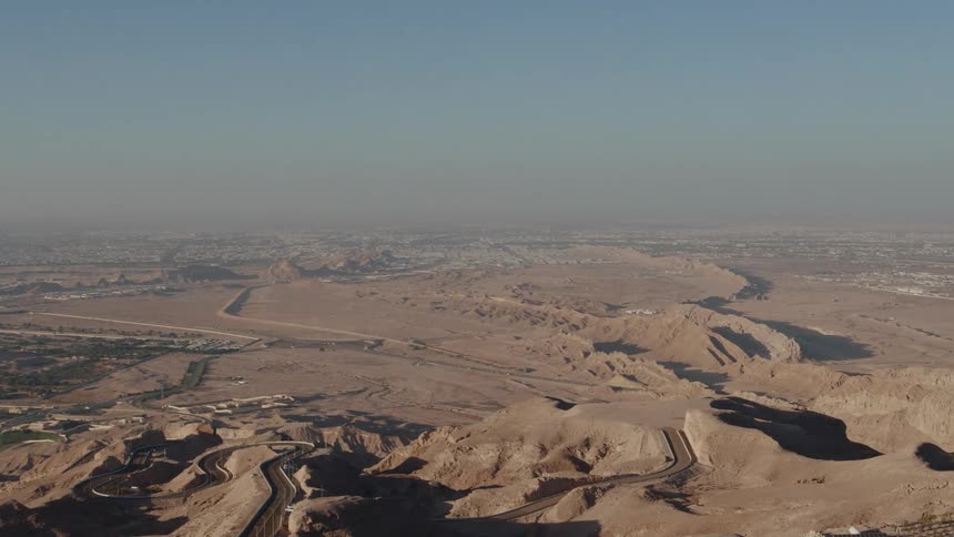 Aerial panorama of a city and roads in the midst of the desert in Abu Dhabi