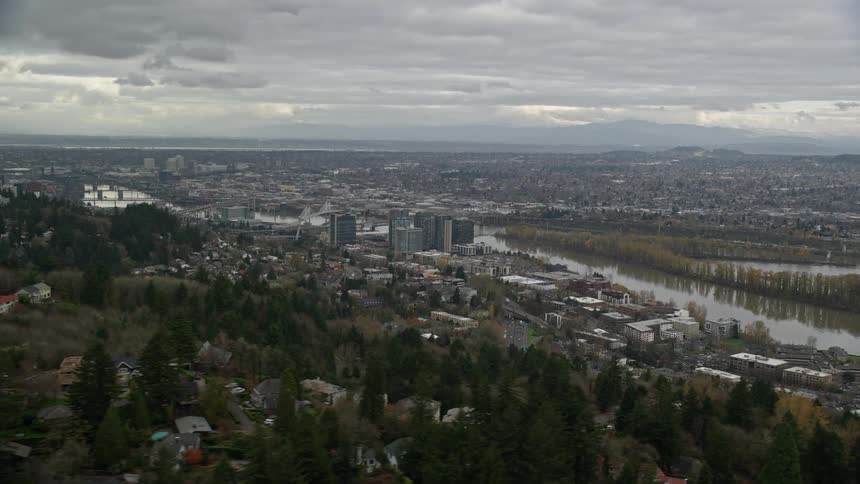 An aerial view of a city with urban and metropolitan regions and there is a lake
