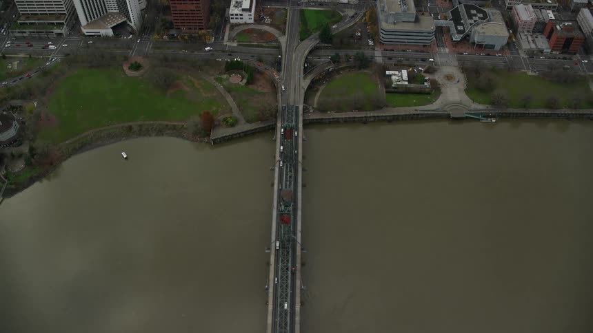 Aerial of bridges cars and buildings in a metropolitan area at midday