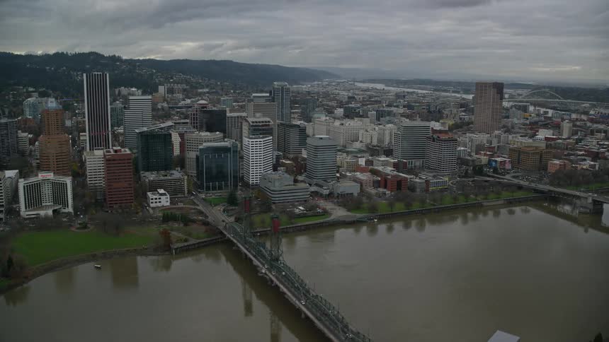 Aerial view of bridges over a river on a waterfront city at evening