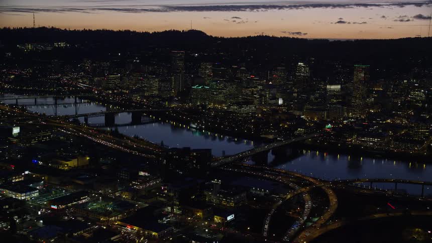 Aerial view of a river through a city at evening