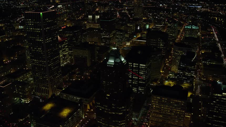 Aerial panorama of a nighttime metropolis with skyscrapers and intersections