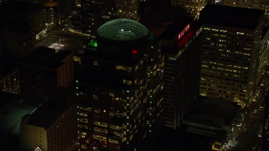 Night panorama of a metropolis with skyscrapers and modern architecture including domed structures
