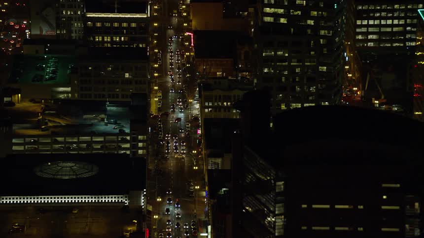 A city lit up at night is shown from an aerial view