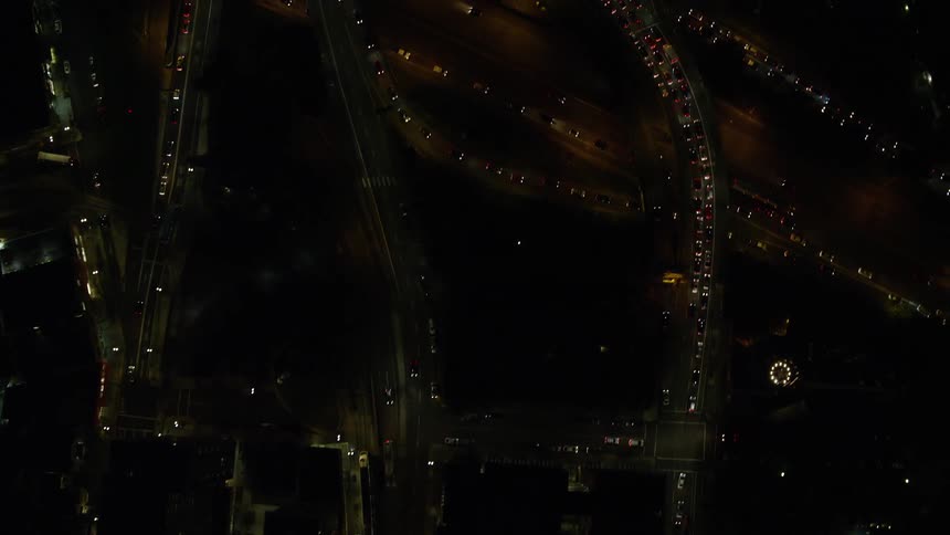 Aerial view of illuminated streets and vehicles driving highways