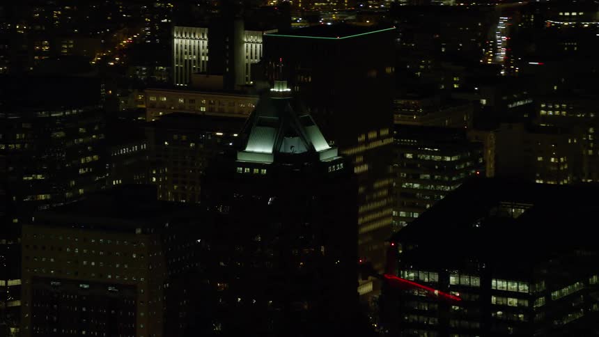 Aerial view of illuminated towers and skyscrapers in the city at night