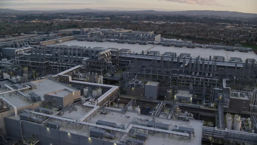 Aerial panorama of a factory amidst an urban city in the morning