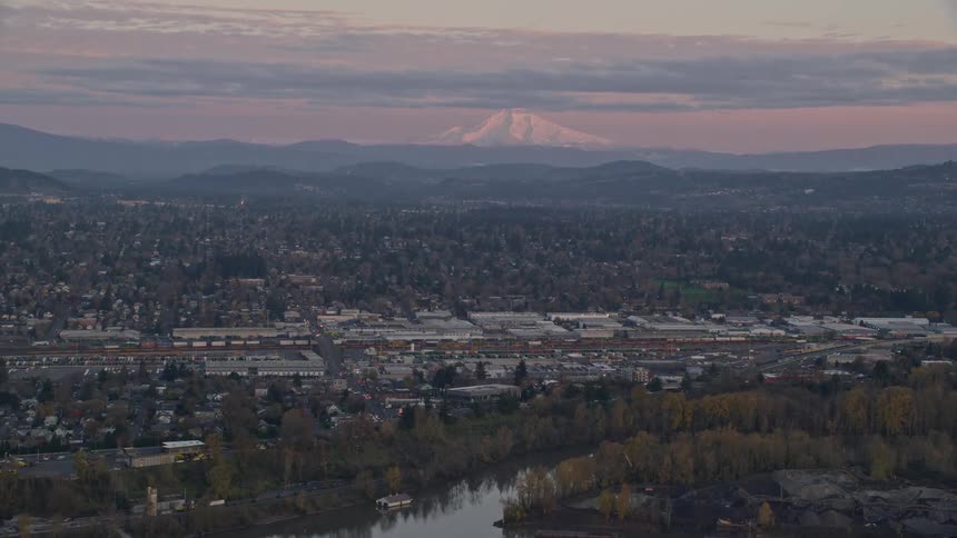 Aerial view of a town next to a mountain peak