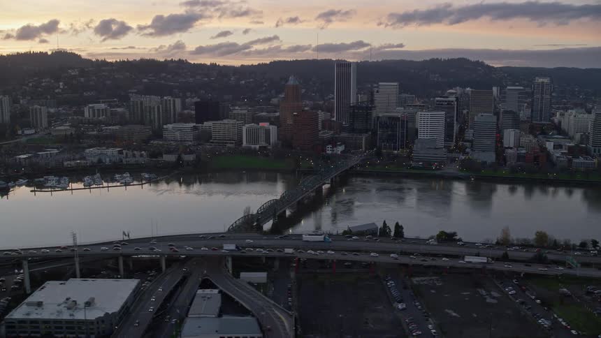 Aerial view of bridges over a river on a waterfront city at evening