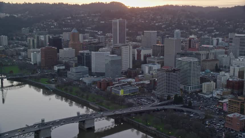 Skyline of a big city with a lake during sunset