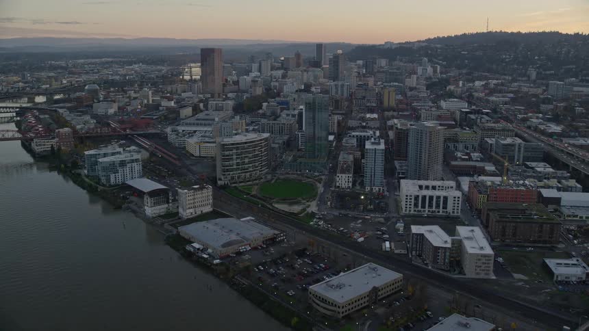 Aerial view of bridges over a river on a waterfront city at evening