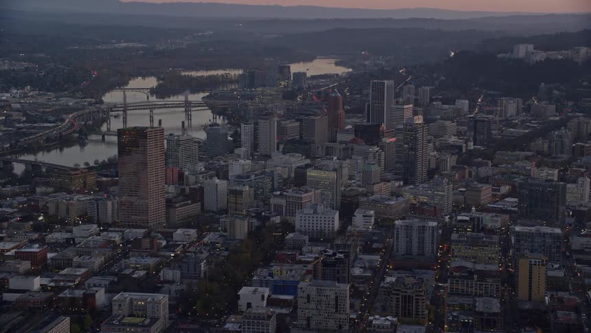 Aerial view of a waterfront city at evening