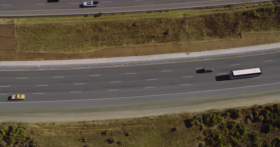 Highway traffic moves steady on a sunny day
