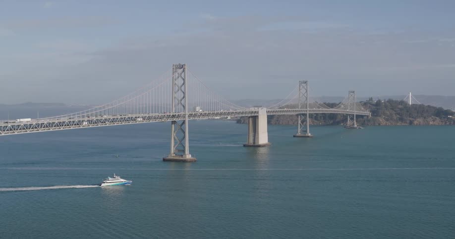 Aerial of a road bridge suspended over the sea during the day