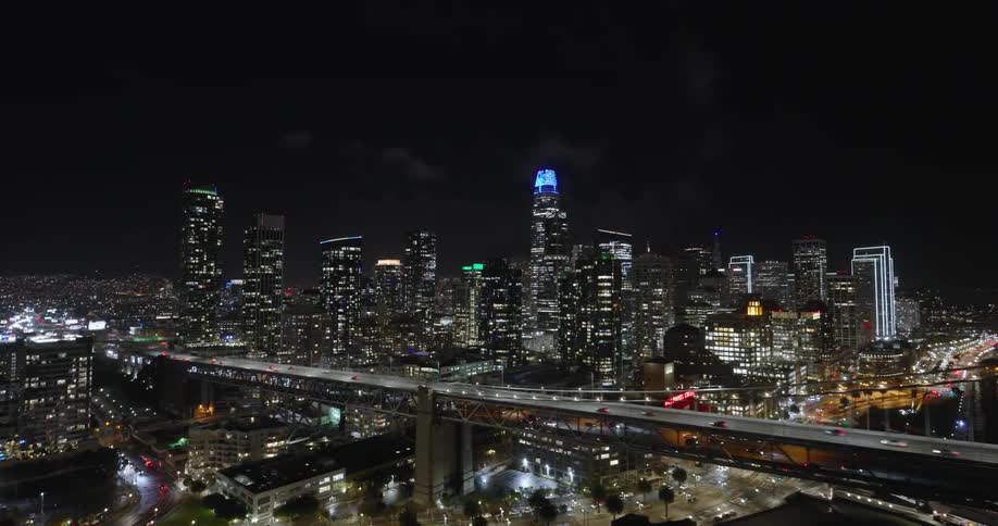 Aerial panorama of a metropolis with a highway under a bridge over the sea