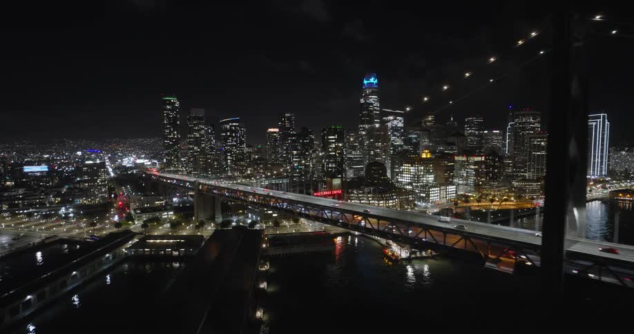 Aerial panorama of a metropolis with nighttime skyscrapers by the sea