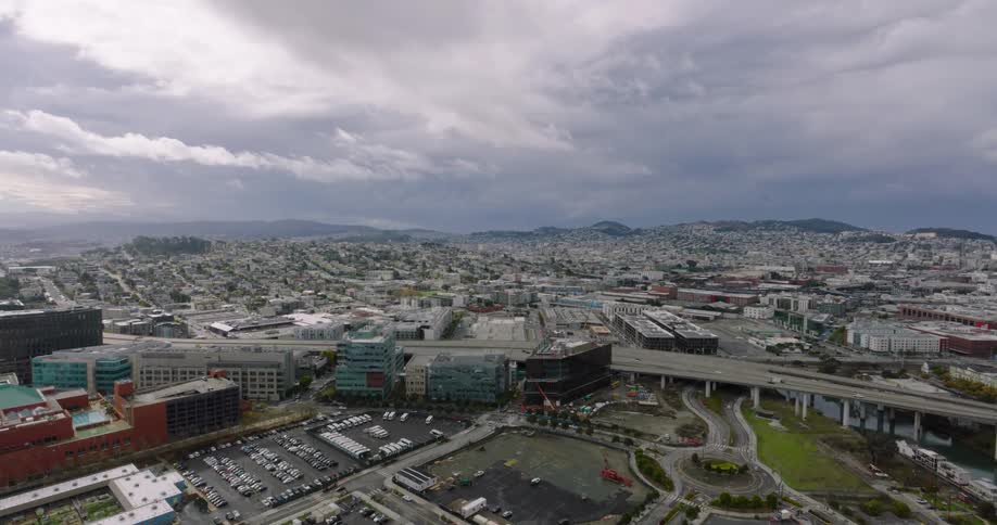 An aerial view of a city with lowrise buildings and a small overpass