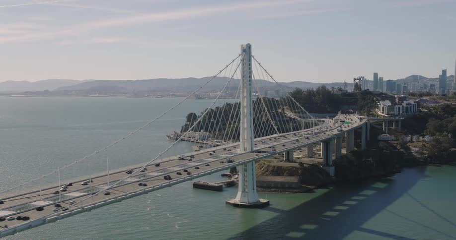 Panorama of a suspended bridge over the sea with traffic in daylight
