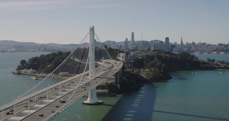 Cars moving on a suspension bridge in a metropolitan area at midday