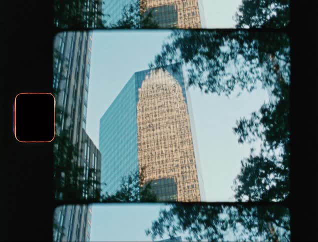 Closeup of a reflective building on a cloudless day with a blue sky
