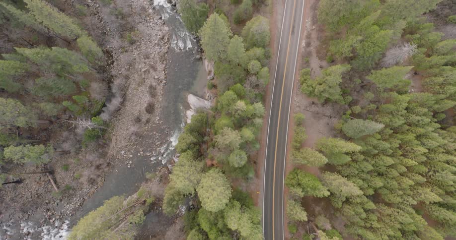 Aerial view of highway near a river and forest