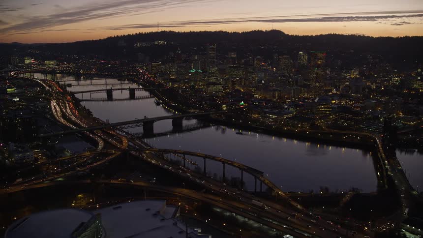 Skyline of a metropolitan city with a watercourse during dusk