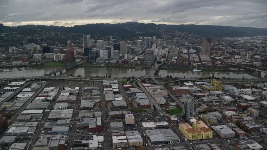 Aerial panorama of a metropolis with a central lake and a mountain range on the horizon