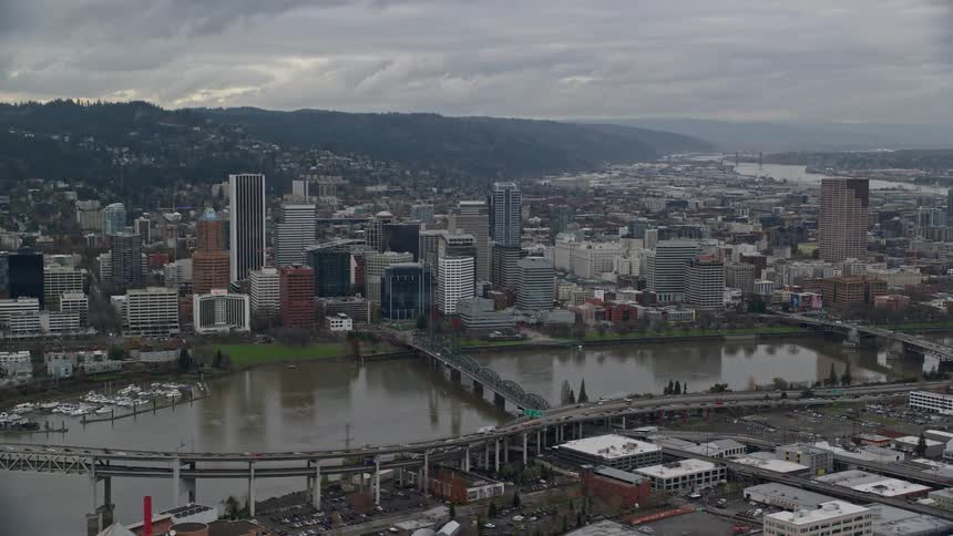 Aerial view of bridges over a river on a waterfront city at evening