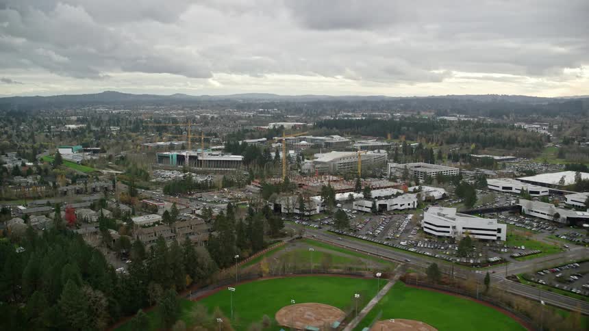 Aerial view of construction cranes on a small town