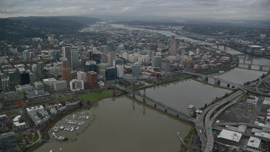 Aerial panorama of a metropolis with a central lake bridges and a cloudy sky