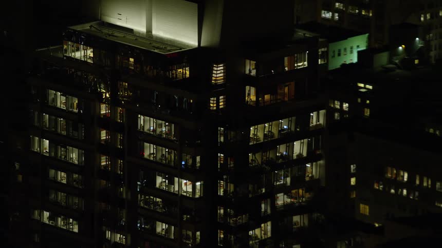 Aerial panorama of an illuminated residential building at night