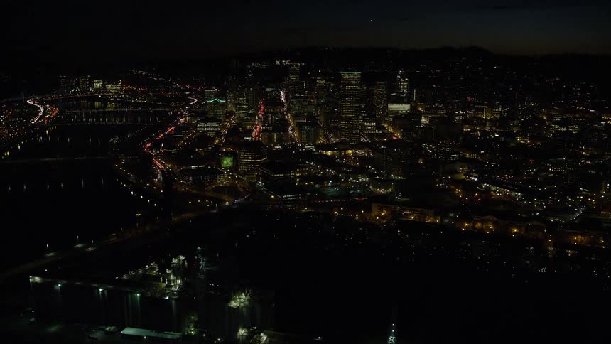 An aerial view of a city at night with many lights on