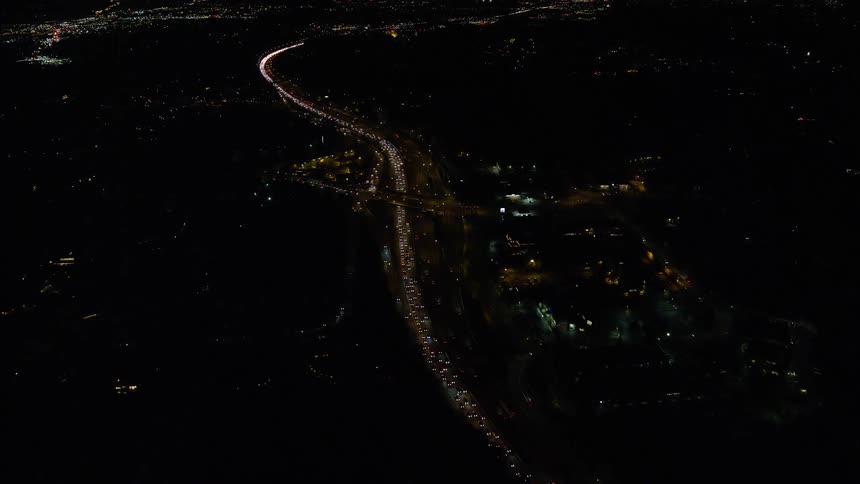 Aerial view highway and vehicle headlights
