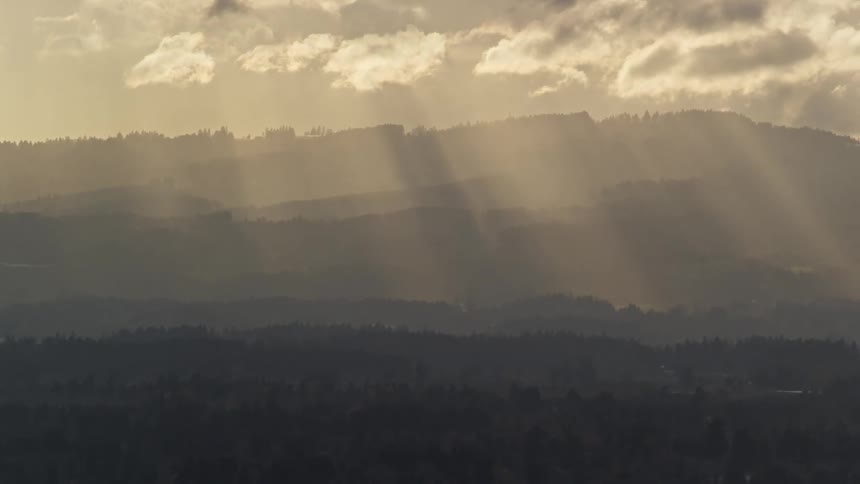 Aerial view of sunlight through clouds over the countryside
