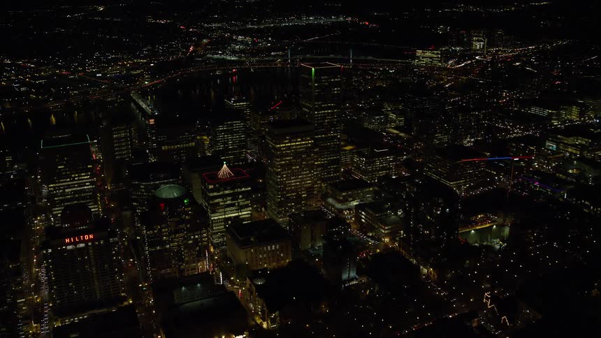 Skyline of a city with busy avenues at night